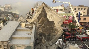 Rescue personnel work at the site where a 17-storey apartment building collapsed, after an earthquake in Tainan